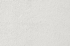 a white stucco wall textured with paint