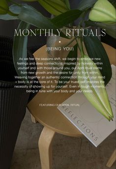 a plant sitting on top of a wooden table next to a sign that reads, monthly rituals being you