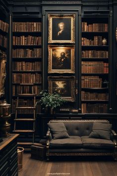 a room with bookshelves, couch and paintings on the wall in front of it