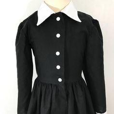 This is an adorable black shirt dress with a full skirt. I could also make it out of different fabrics, if you are looking for a custom shirt dress, message me for customization. accessories not included. This dress is perfect for Halloween Thank you for checking out my listing! Fitted Doll Collar Dress For School, Classic Cotton Party Dress, Long Sleeve Cotton School Dress, Preppy Fitted Collared Dress, Fitted Buttoned Dress For Costume Party, Fitted Dress With Buttons For Costume Party, Long Sleeve Cotton Dresses With Covered Buttons, Black Peter Pan Collar Dress For Fall, Classic Long Sleeve Costume Dress