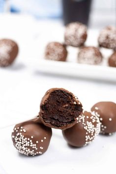 chocolate truffles with white sprinkles on a plate