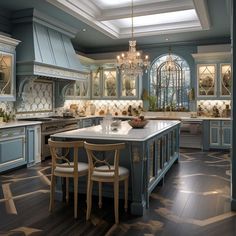 a large kitchen with blue cabinets and an island in front of the stove top oven