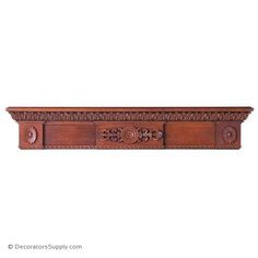 an ornate wooden shelf with carvings on the top and bottom, is shown against a white background