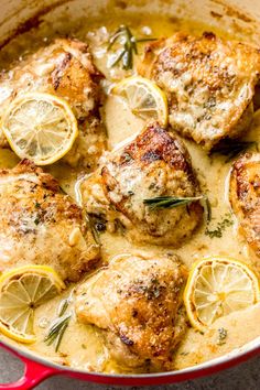 chicken with lemons and herbs in a pan