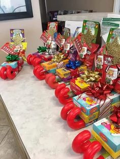 a table topped with lots of red and yellow boxes filled with candy, candies and other items