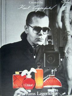 a man holding an old camera in front of his face and wearing sunglasses with the caption chums lagerfield