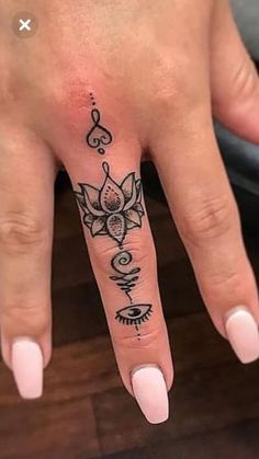 a woman's hand with a tattoo on it