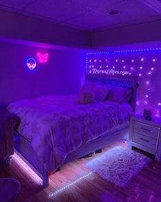 a bedroom with pink lights and a bed