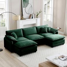 a living room with a large green couch in the center and a white rug on the floor