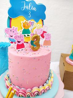 peppa pig birthday cake with name and age on top, surrounded by other decorations