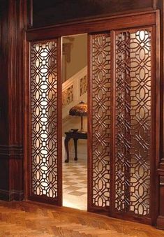 an ornate wooden room divider with glass doors