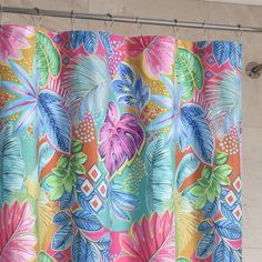 a colorful shower curtain hanging on the side of a wall