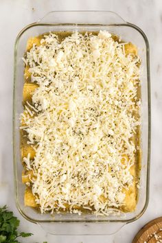 a casserole dish with cheese and parmesan on top