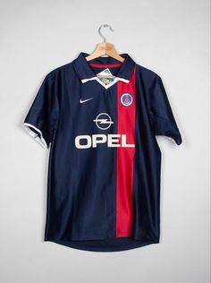 a soccer shirt hanging on a hanger with the word opel printed on it