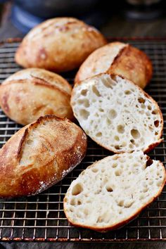 several loaves of bread sitting on a cooling rack