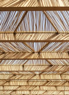 the inside of a wooden structure that is made out of bamboo