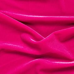 a bright pink fabric is shown in close up