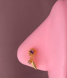 a close up of a pink object with a gold ring on it's side