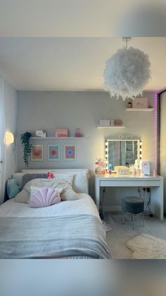 a bedroom with a bed, desk and mirror