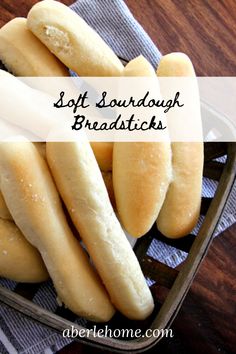 soft sourdough breadsticks in a basket on a table