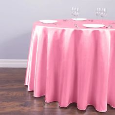 a pink table cloth with wine glasses on it