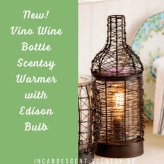 a table with some candles on it and the words, new vine bottle scenty warmer with edison bulb