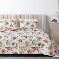 an ocean themed bed set with starfish and corals on the comforter is shown