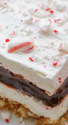 a close up of a dessert on a plate with white frosting and candy canes