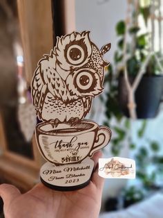 an owl sitting on top of a coffee cup