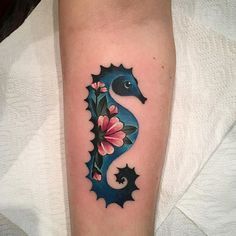 a sea horse with flowers on its leg