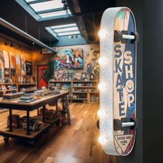 a skateboard mounted to the side of a wall in a room with wooden floors