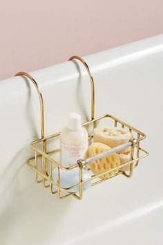 a bathtub caddy with two soaps and toothbrushes in it