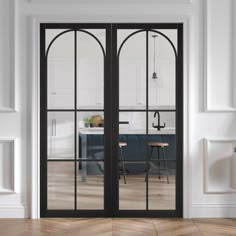 an open door leading to a kitchen with white walls and wooden floors, in front of a breakfast nook