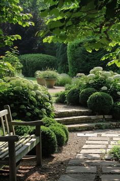 a wooden bench sitting in the middle of a garden