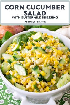 corn cucumber salad with buttermilk dressing in a white bowl on a green and white tablecloth