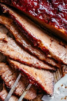 barbecue ribs with bbq sauce and tongs on a cutting board, ready to be cooked