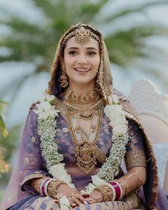 a woman in a purple and gold bridal outfit