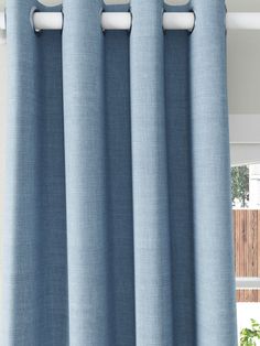 a blue curtain hanging on the side of a window