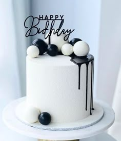 a birthday cake with black and white decorations