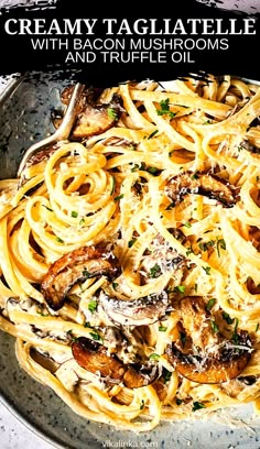 a plate full of pasta with mushrooms and parmesan cheese on top, in front of the words creamy tagliatelle with bacon mushrooms and truffle oil