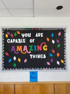 a bulletin board that says you are capable of amazing things hanging on the school wall