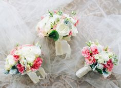 three bridal bouquets with white and pink flowers