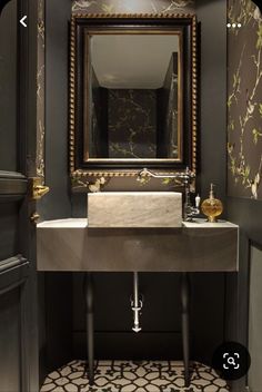 a bathroom sink sitting under a mirror next to a doorway