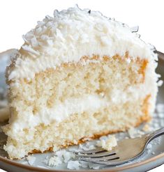 a slice of coconut cake on a plate with a fork