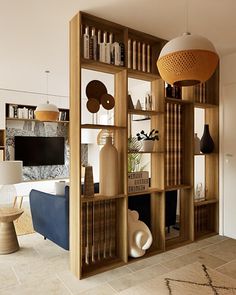 a living room filled with furniture and bookshelves next to a wall mounted tv