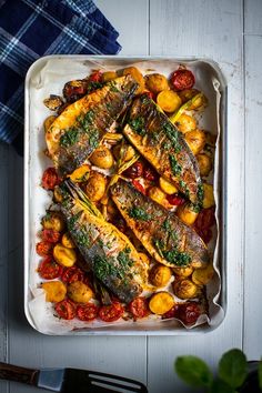 an overhead view of fish and vegetables in a dish