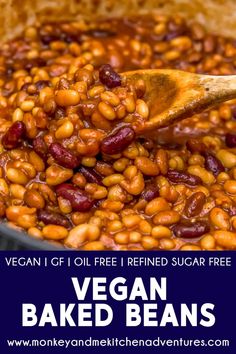 vegan baked beans in a pot with a wooden spoon and text overlay that reads vegan baked beans