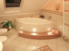 a bathroom with a large jacuzzi tub next to a window