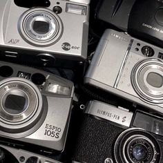 several different types of cameras sitting next to each other