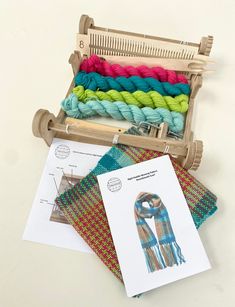 an old weaving loom with several different colors of yarn in it and instructions on how to use the loom